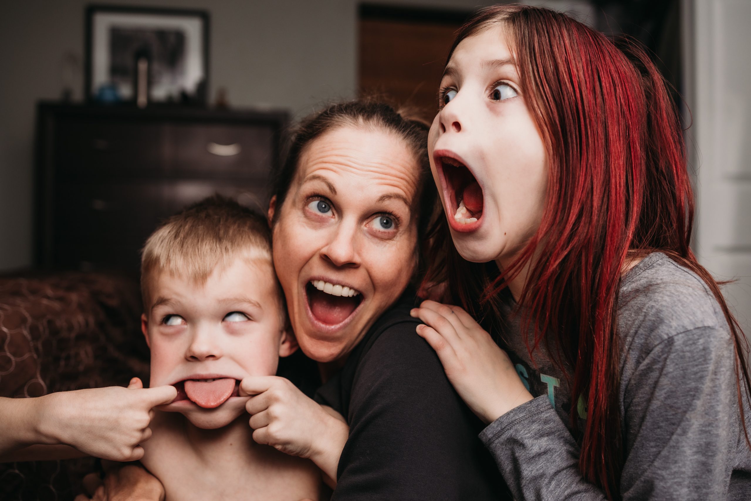 Lydia Fine with son making silly face and daughter making silly face.