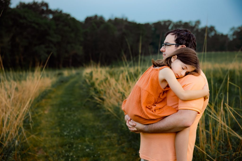 Dad holding a little girl in his arms