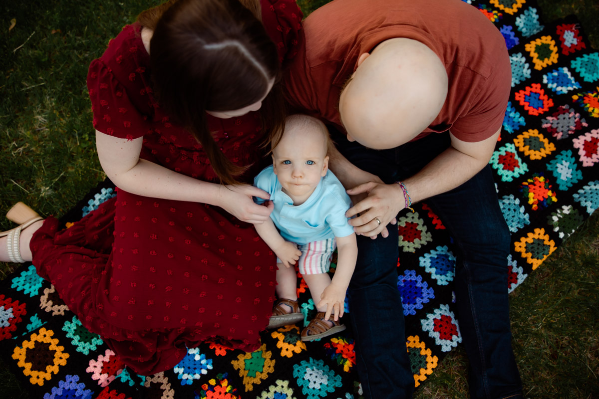 Mom and Dad with baby on a granny afghan