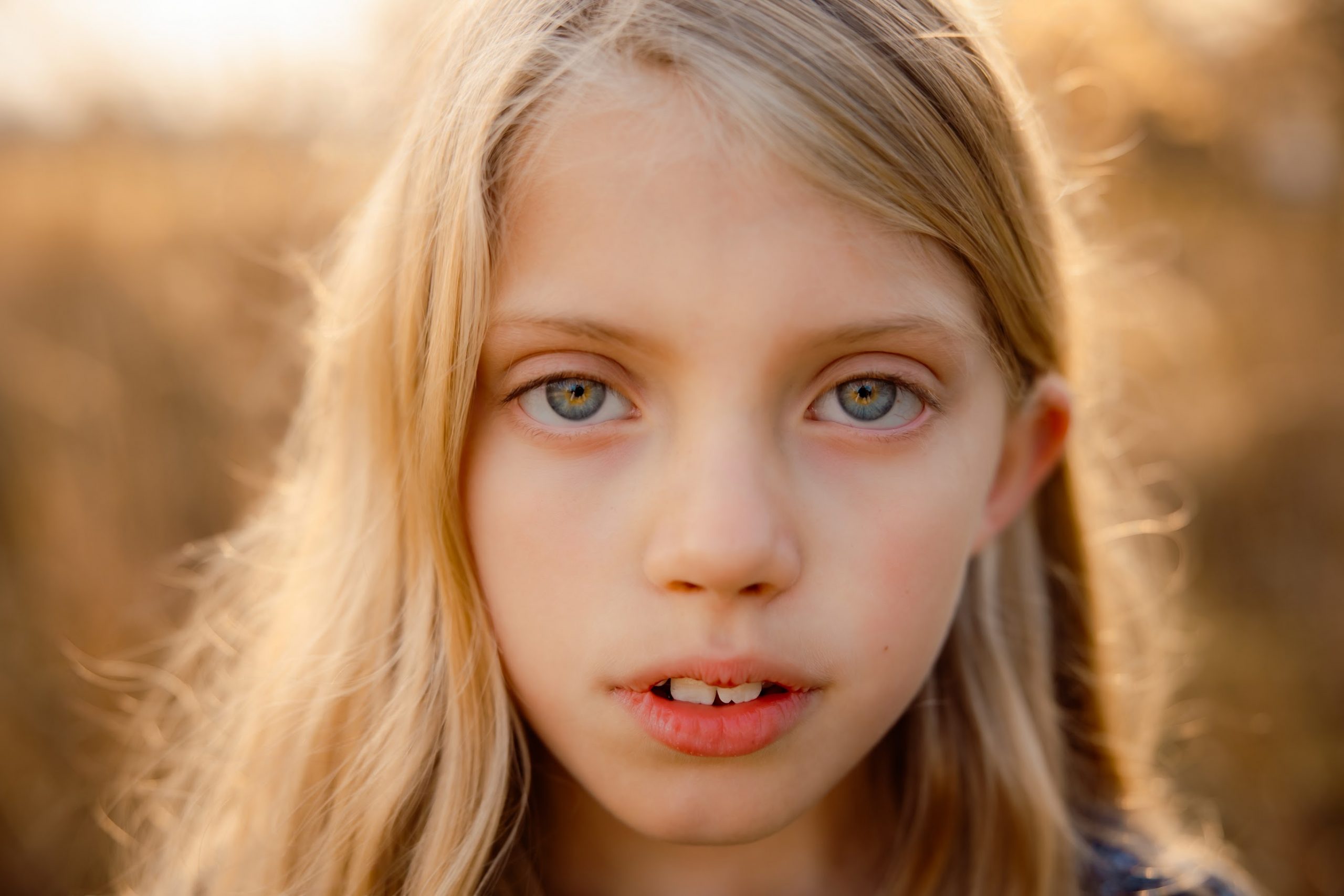 Young blonde girl with blue gold eyes