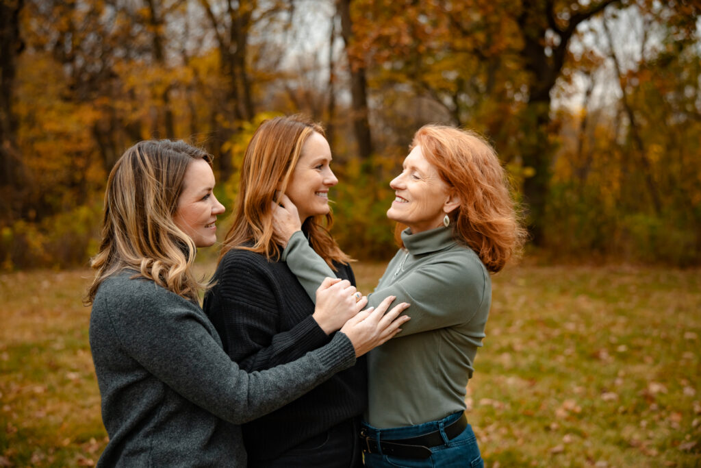 Should I wear my hair down for family photos? Three women, an older mother in her late 60s with two grown daughters, on a windy fall day.